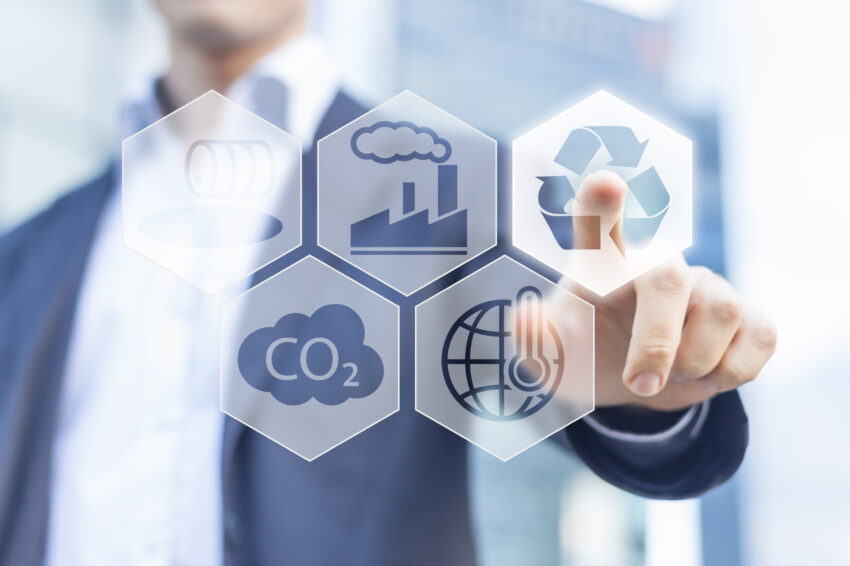 Businessman,touching,recyclable,button,for,sustainable,development,with,office,buildings